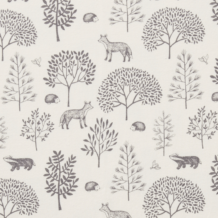 Illustration of woodland creatures and trees on a Wilson & Frenchy Organic Cotton Bassinet Sheet fabric pattern.