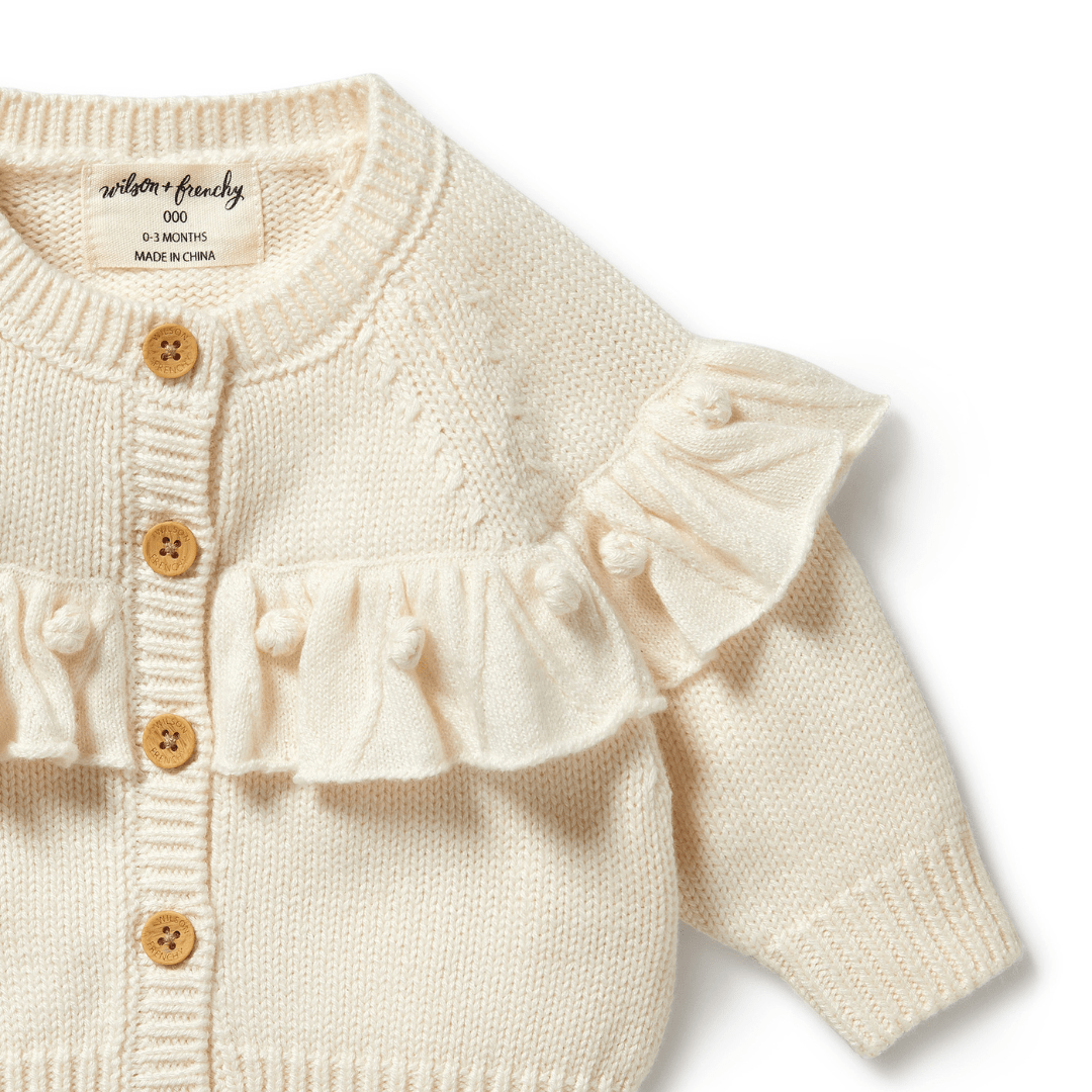 Close-Up-Of-The-Buttons-And-Ruffle-On-Wilson-And-Frenchy-Knitted-Ruffle-Cardigan-Ecru-Naked-Baby-Eco-Boutique