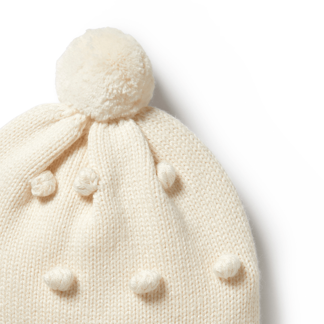 Close-Up-Of-Wilson-And-Frenchy-Knitted-Bauble-Hat-Ecru-Naked-Baby-Eco-Boutique