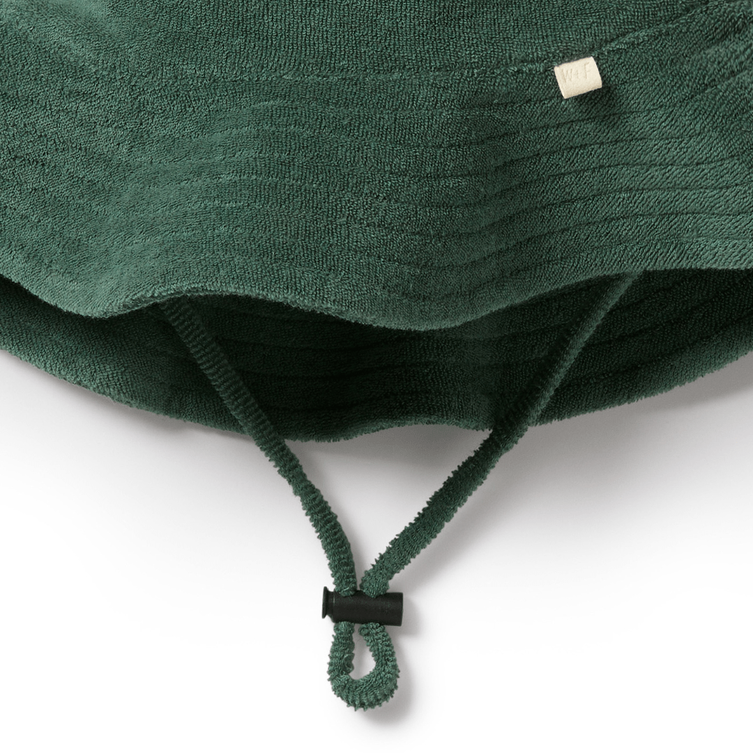A green Wilson & Frenchy Organic Terry Sunhat in LUCKY LAST - SUN DIAL - 6-12 MONTHS on a white background.