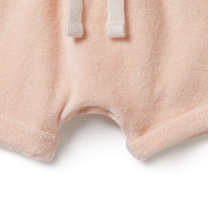 A baby's Wilson & Frenchy Organic Terry Cuffed Shorts with a white drawstring, offering comfort.