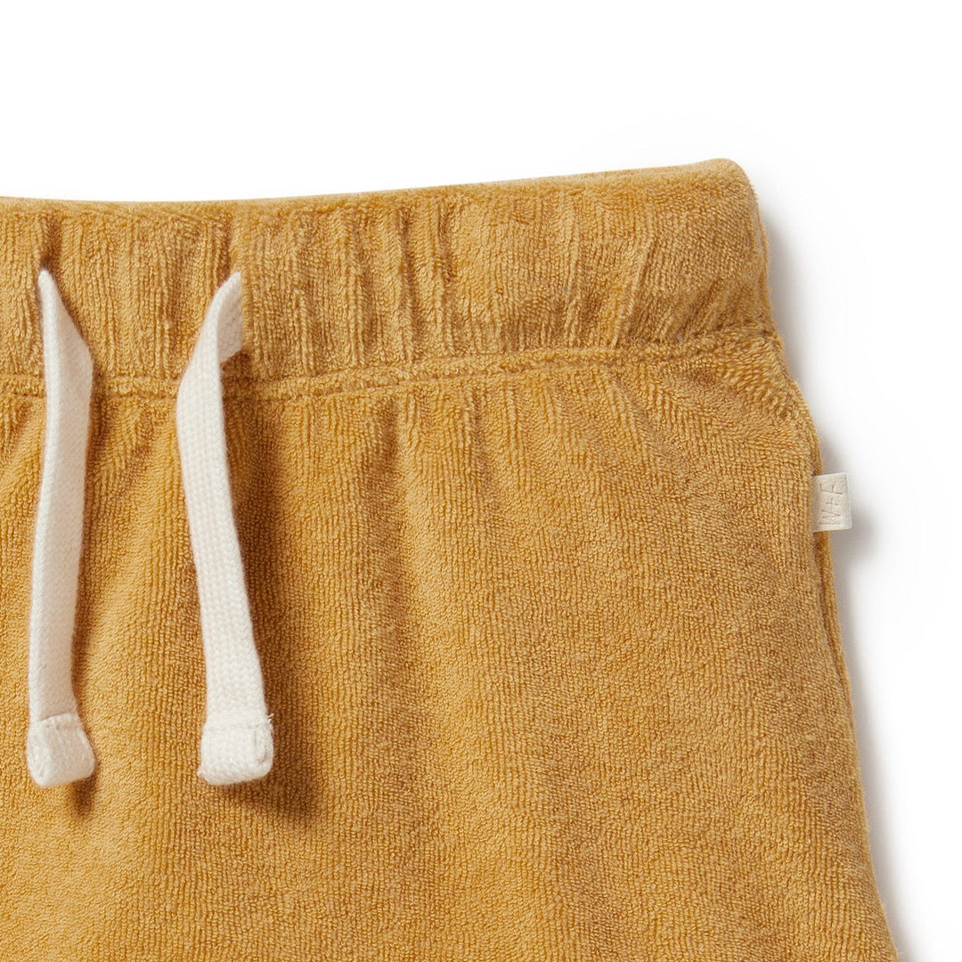 A baby's Wilson & Frenchy Organic Terry Cuffed Shorts with white drawstrings, providing both comfort and style.