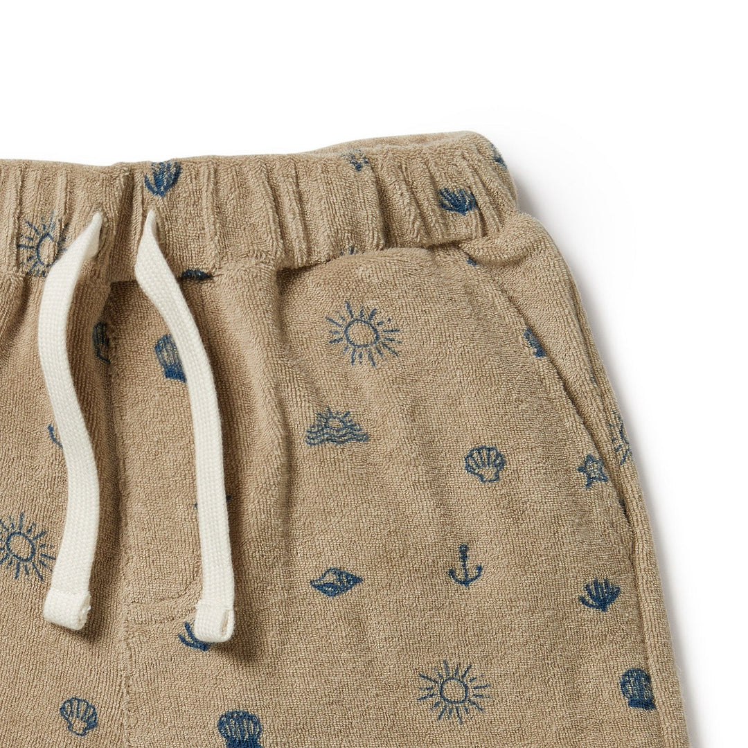 A Wilson & Frenchy Organic Terry Kids Shorts with seashells and stars on them, perfect for summer days.