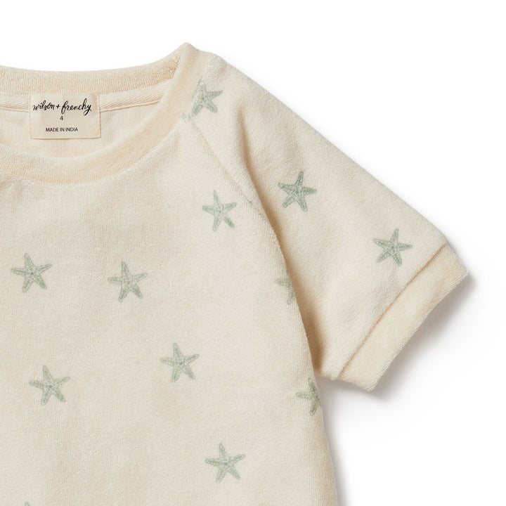 A Wilson & Frenchy Tiny Starfish Organic Terry Kids Sweat Top with stars on it made from organic cotton.