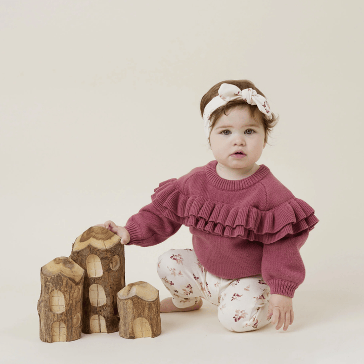 Cute-Little-Girl-Kneeling-Wearing-Aster-and-Oak-Organic-Ruffle-Knit-Jumper-Berry-Naked-Baby-Eco-Boutique