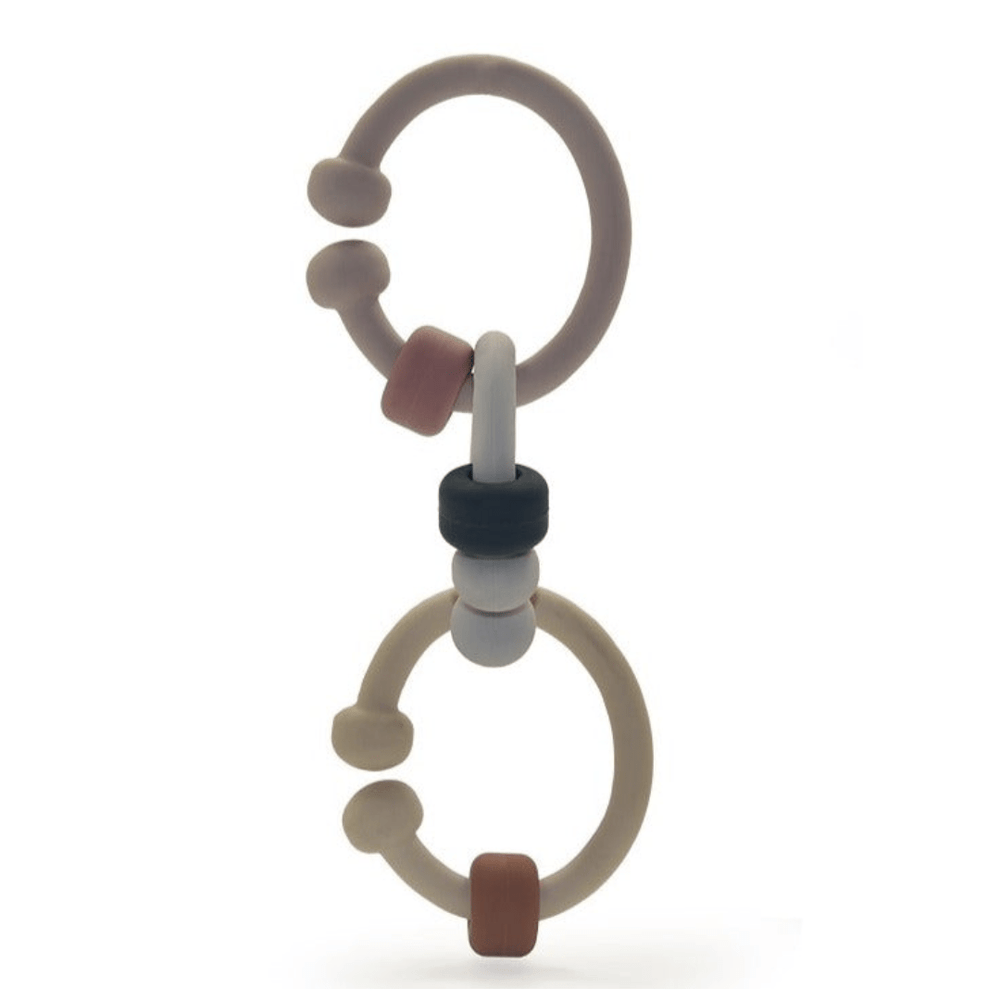 A Classical Child Silicone Detail Links teether, providing teething relief, shaped like a ring and featuring brown and black accents. It is placed on a white background.