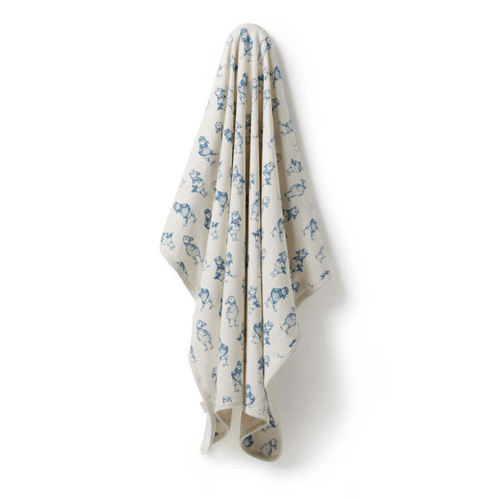 A luxury Wilson & Frenchy Organic Baby Swaddle Blanket - LUCKY LAST - TROPICAL GARDEN ONLY with blue flowers on it.
