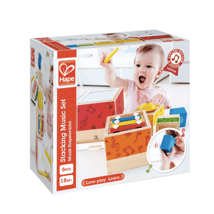 A baby is playing with a Hape Stacking Music Set, a set of musical stacking blocks.