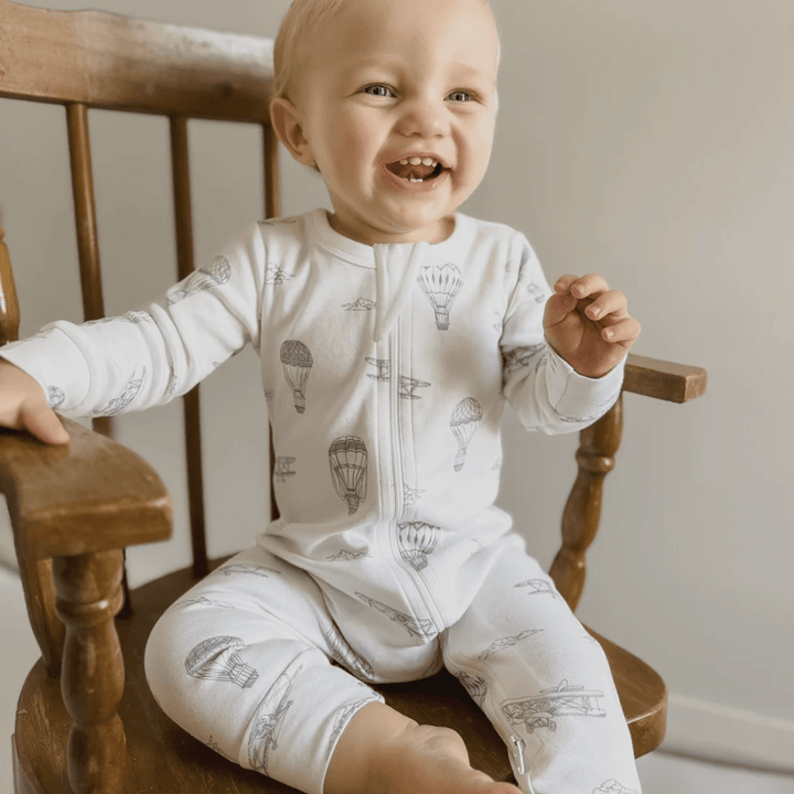 Happy-Baby-Wearing-Aster-And-Oak-Organic-Long-Sleeved-Zip-Romper-Air-Balloon-Naked-Baby-Eco-Boutique