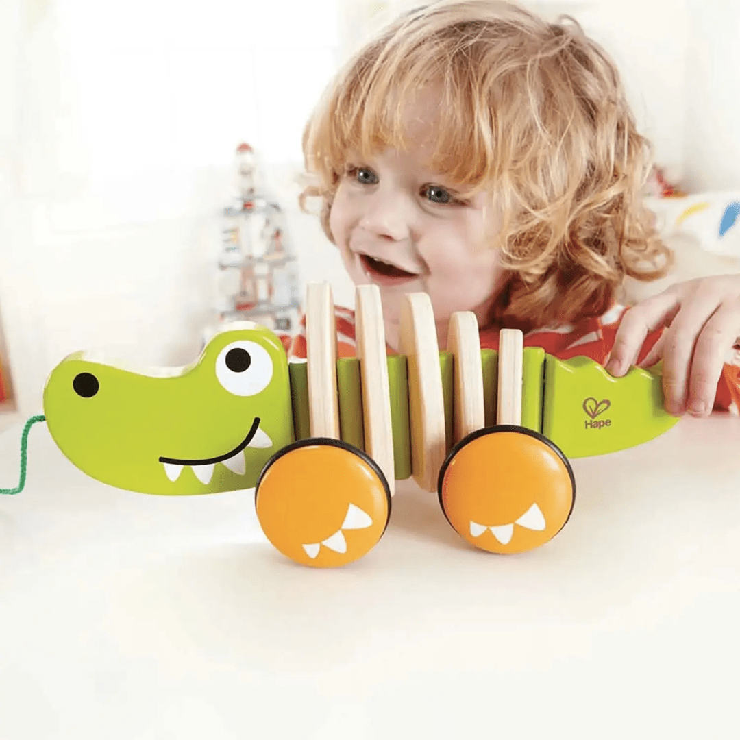 Happy-Boy-Playing-With-Hape-Walk-A-Long-Croc-Naked-Baby-Eco-Boutique