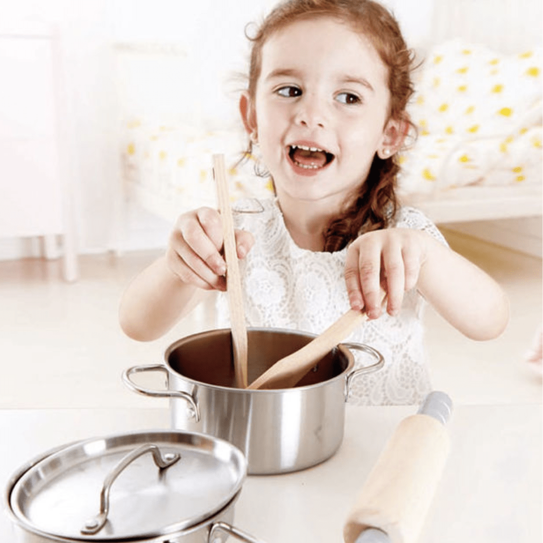 Happy-Girl-Mixing-With-Hape-Chefs-Cooking-Set-Naked-Baby-Eco-Boutique