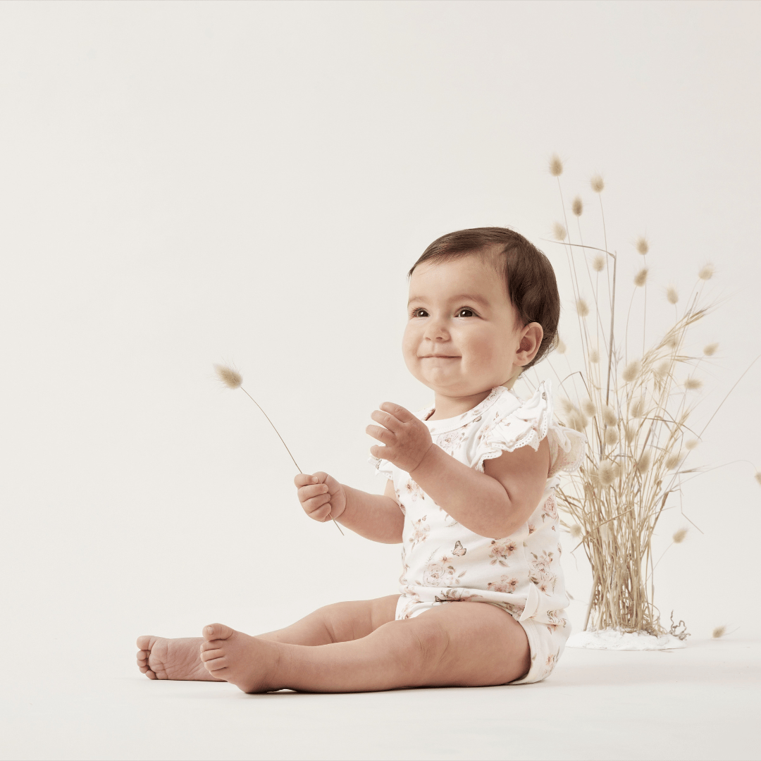 Happy-Girl-Wearing-Aster-And-Oak-Organic-Cotton-Butterfly-Lace-Onesie-Naked-Baby-Eco-Boutique