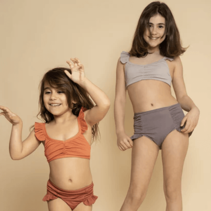 Happy-Girls-Wearing-Grech-And-Co-2-Piece-UPF-50-Recycled-Swimsuit-Melon-Sienna-Naked-Baby-Eco-Boutique
