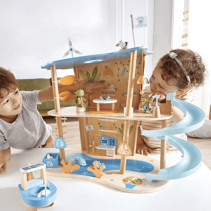 Happy-Kids-Playing-Together-With-Hape-Green-Planet-Ocean-Rescue-Beach-House-Naked-Baby-Eco-Boutique