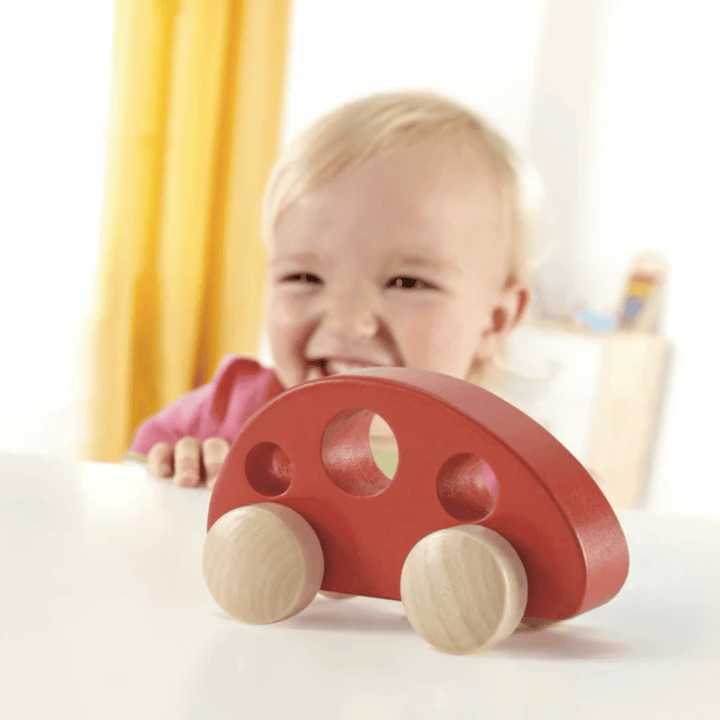 Happy-Little-Baby-Playing-With-Hape-Little-Red-Van-Naked-Baby-Eco-Boutique