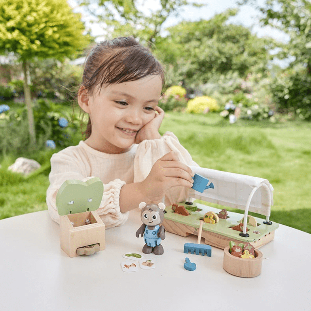 Happy-Little-Girl-Playing-WIth-Hape-Green--Planet-Greenhouse-Set-Naked-Baby-Eco-Boutique