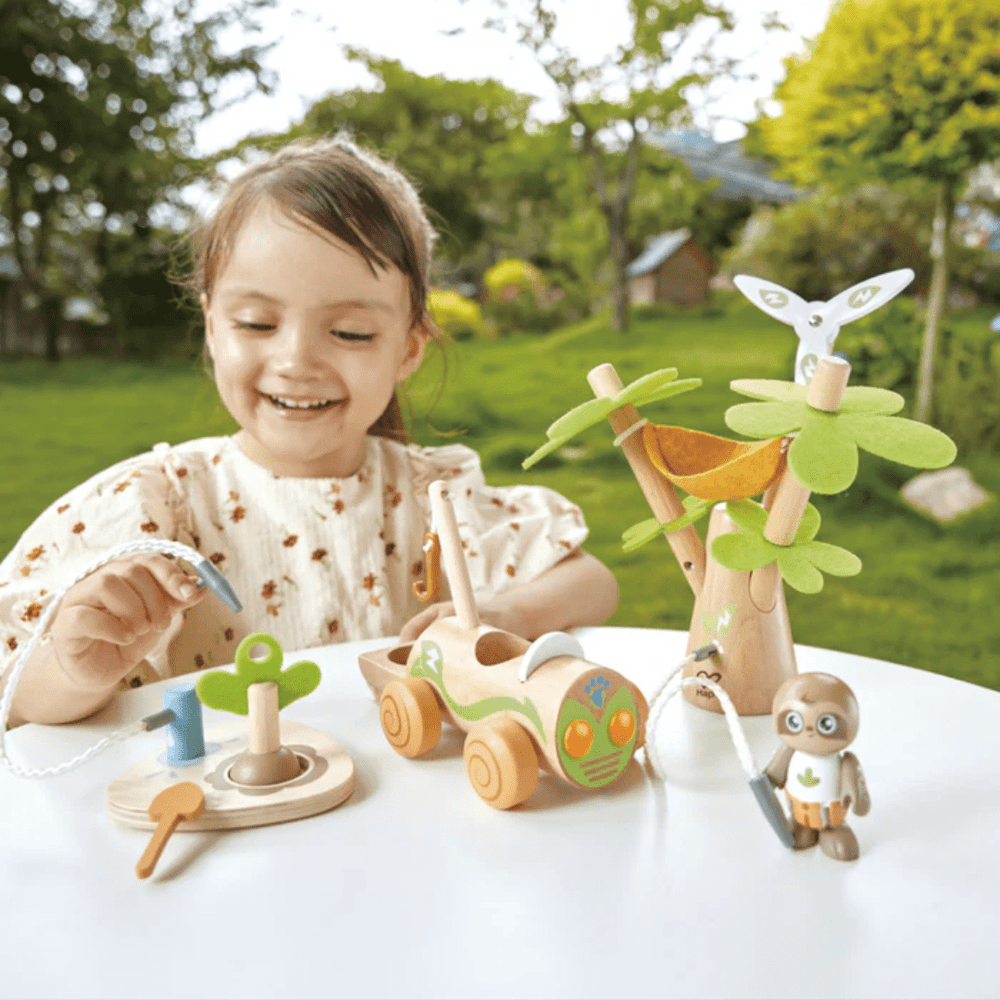 Happy-Little-Girl-Playing-With-Hape-Green-Planet-Green-Vehicle-Set-Naked-Baby-Eco-Boutique