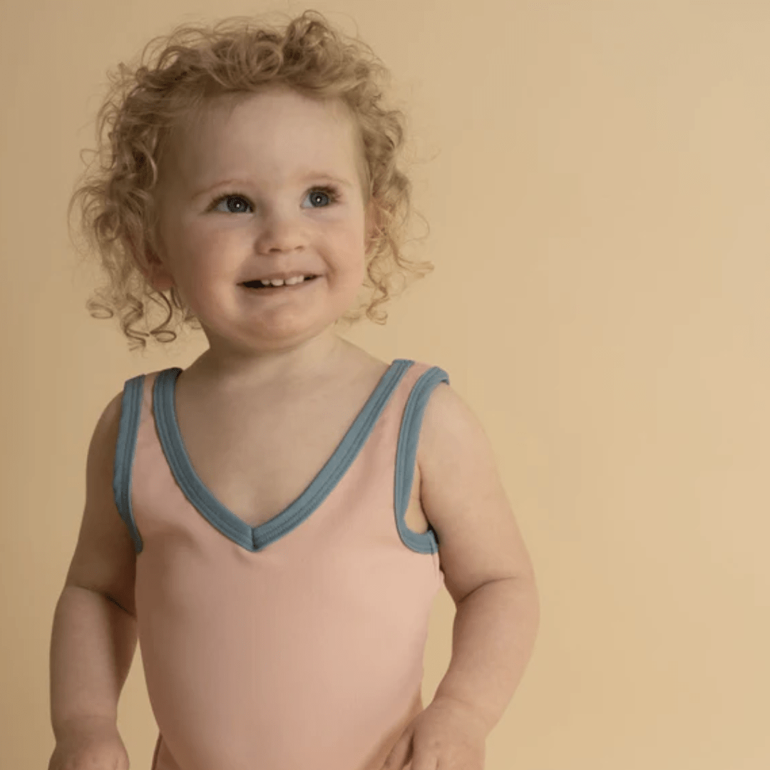 Happy-Wee-Girl-Wearing-Grech-And-Co-Full-Piece-UPF-50-Recycled-Swimsuit-Blush-Bloom-Naked-Baby-Eco-Boutique