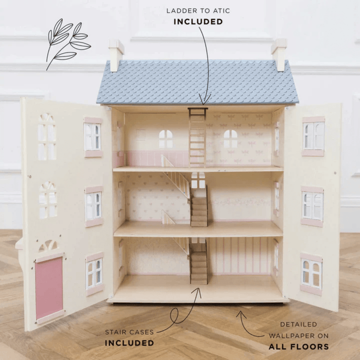 A Le Toy Van Cherry Tree Hall Dollhouse with a pink roof for imaginative adventures.