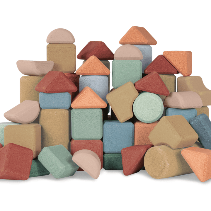 An eco-friendly Korko Block Set, made of cork blocks, stacked in a colorful pile on a white background.