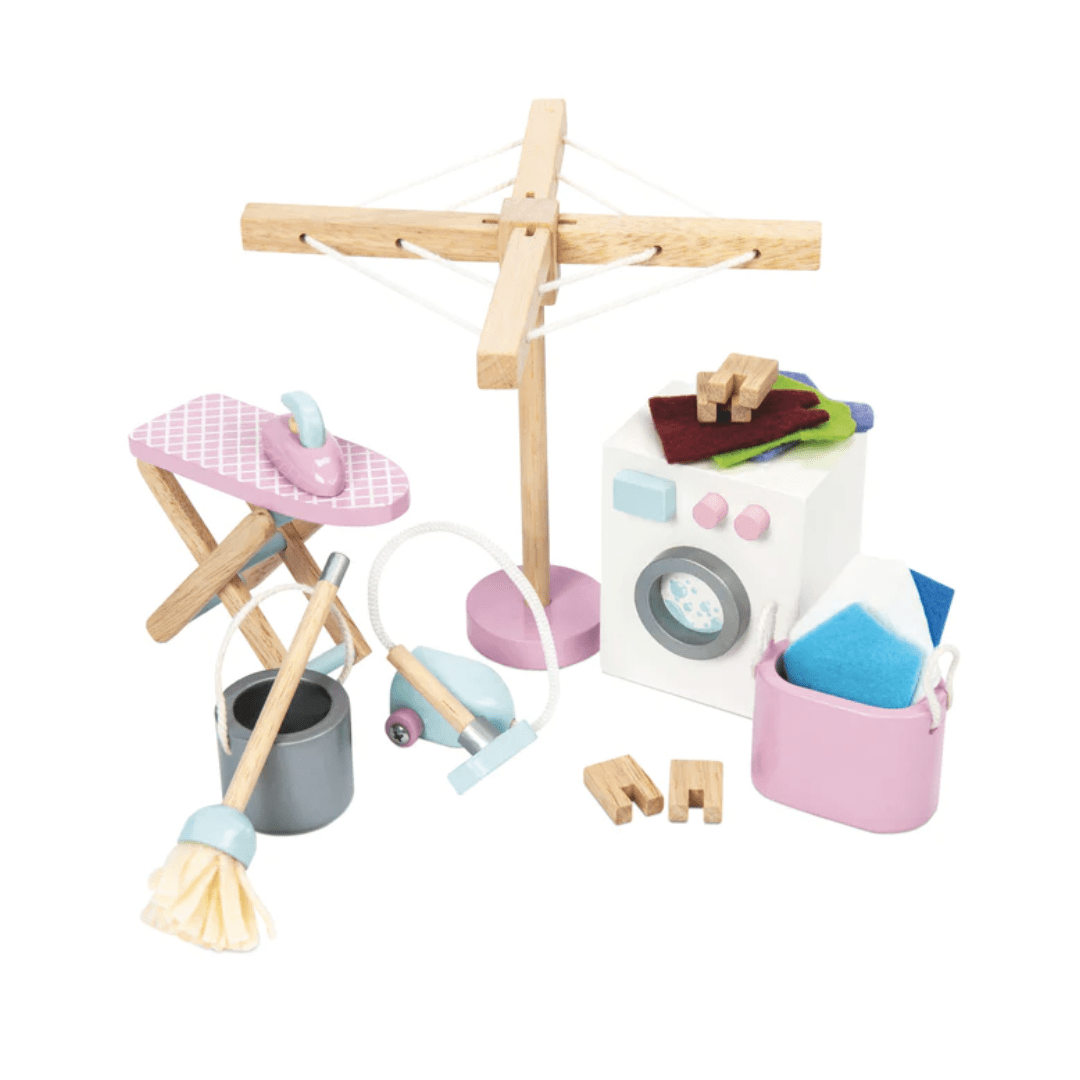 A wooden Le Toy Van doll furniture set with a washing machine in a Le Toy Van Dollhouse Laundry Room Set dollhouse.