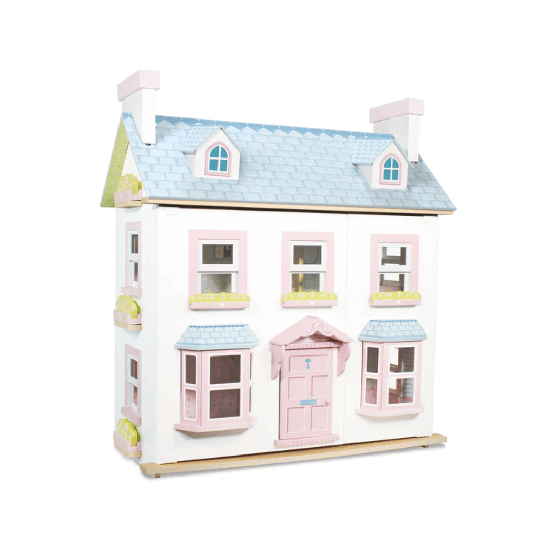 A Le Toy Van Mayberry Manor Dollhouse, with pink and white colors, featuring windows.