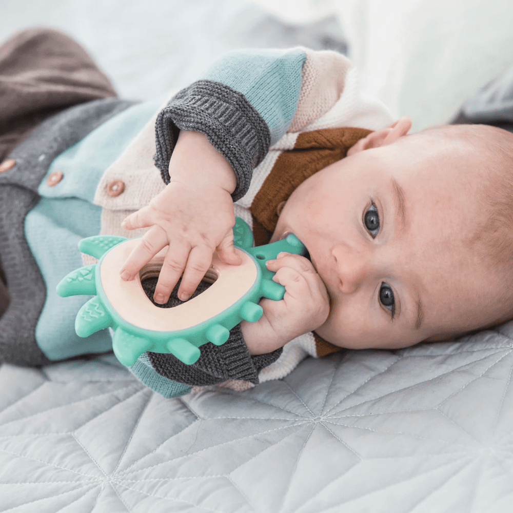 Little-Baby-Chewing-On-Hape-Teether-Hedgehog-Naked-Baby-Eco-Boutique