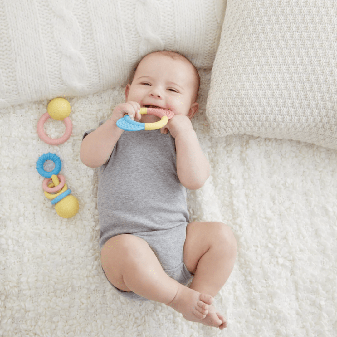 Little-Baby-Chewing-On-Teething-Ring-In-Hape-Rattle-And-Teether-Collection-Naked-Baby-Eco-Boutique