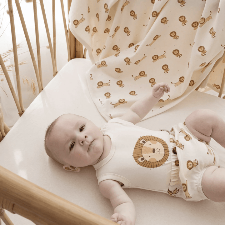 Little-Baby-In-Cot-Wearing-Aster-And-Oak-Organic-Lion-Print-Singlet-Onesie-Naked-Baby-Eco-Boutique