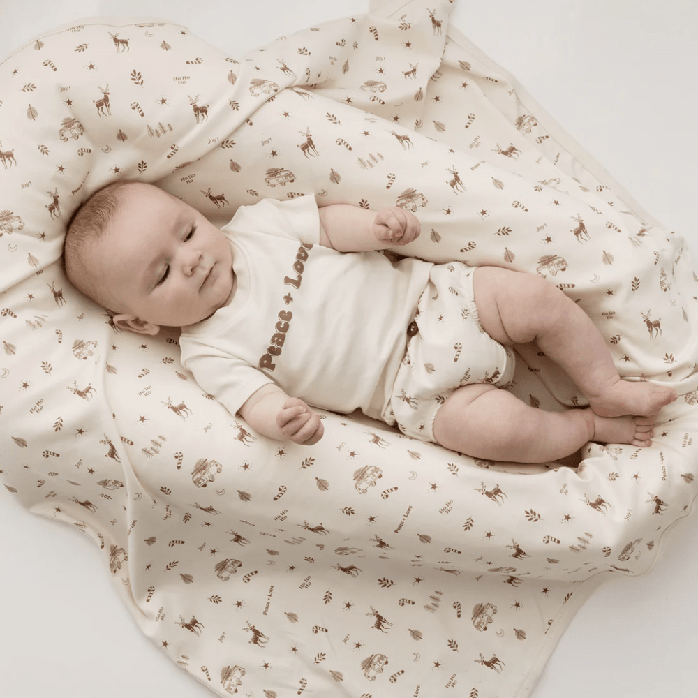 Little-Baby-Lying-On-Aster-And-Oak-Organic-Happy-Holidays-Baby-Swaddle-Wrap-Naked-Baby-Eco-Boutique