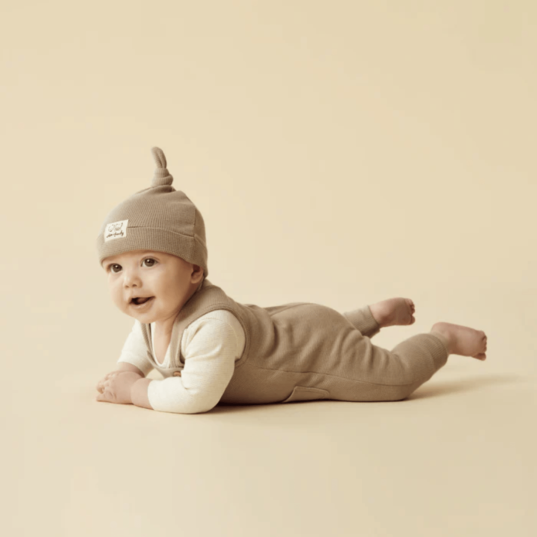 Little-Baby-On-Tummy-Wearing-Wilson-And-Frenchy-Organic-Waffle-Knot-Hat-Mushroom-With-Matching-Overalls-Naked-Baby-Eco-Boutique