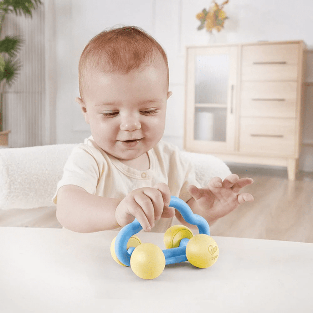 Little-Baby-Playing-With-Hape-Rattle-And-Roll-Toy-Car-Naked-Baby-Eco-Boutique