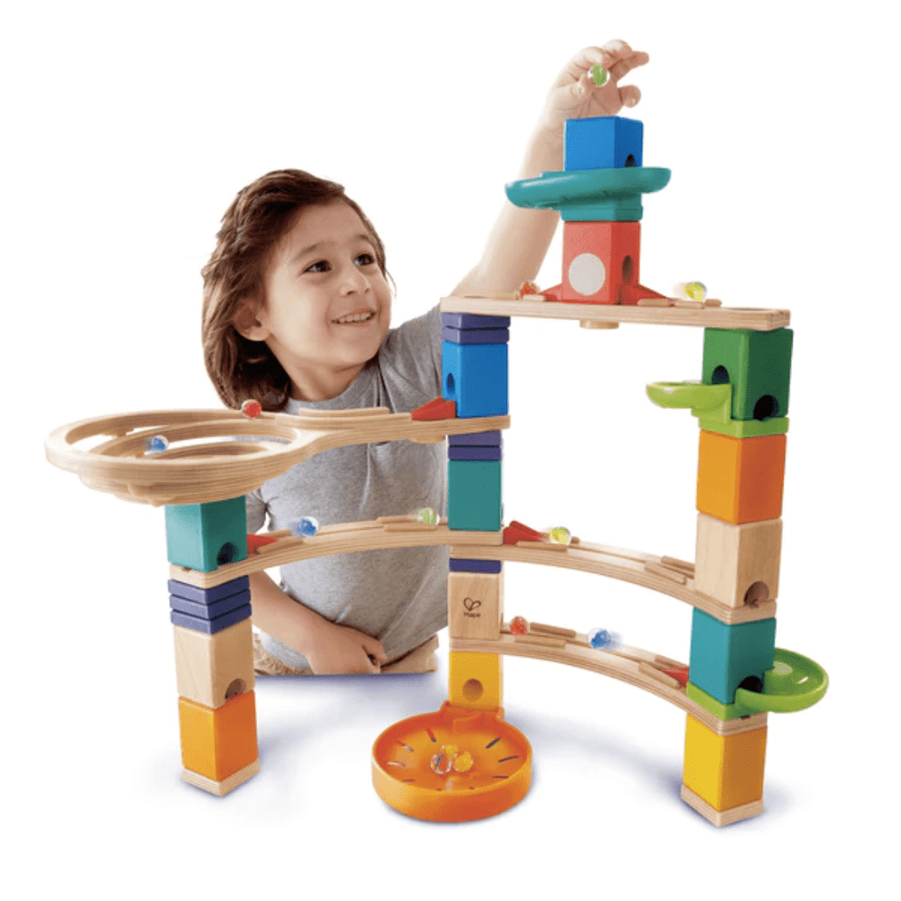 Little-Boy-Dropping-Marble-Into-Hape-Quadrilla-Marble-Run-Cliffhanger-Naked-Baby-Eco-Boutique