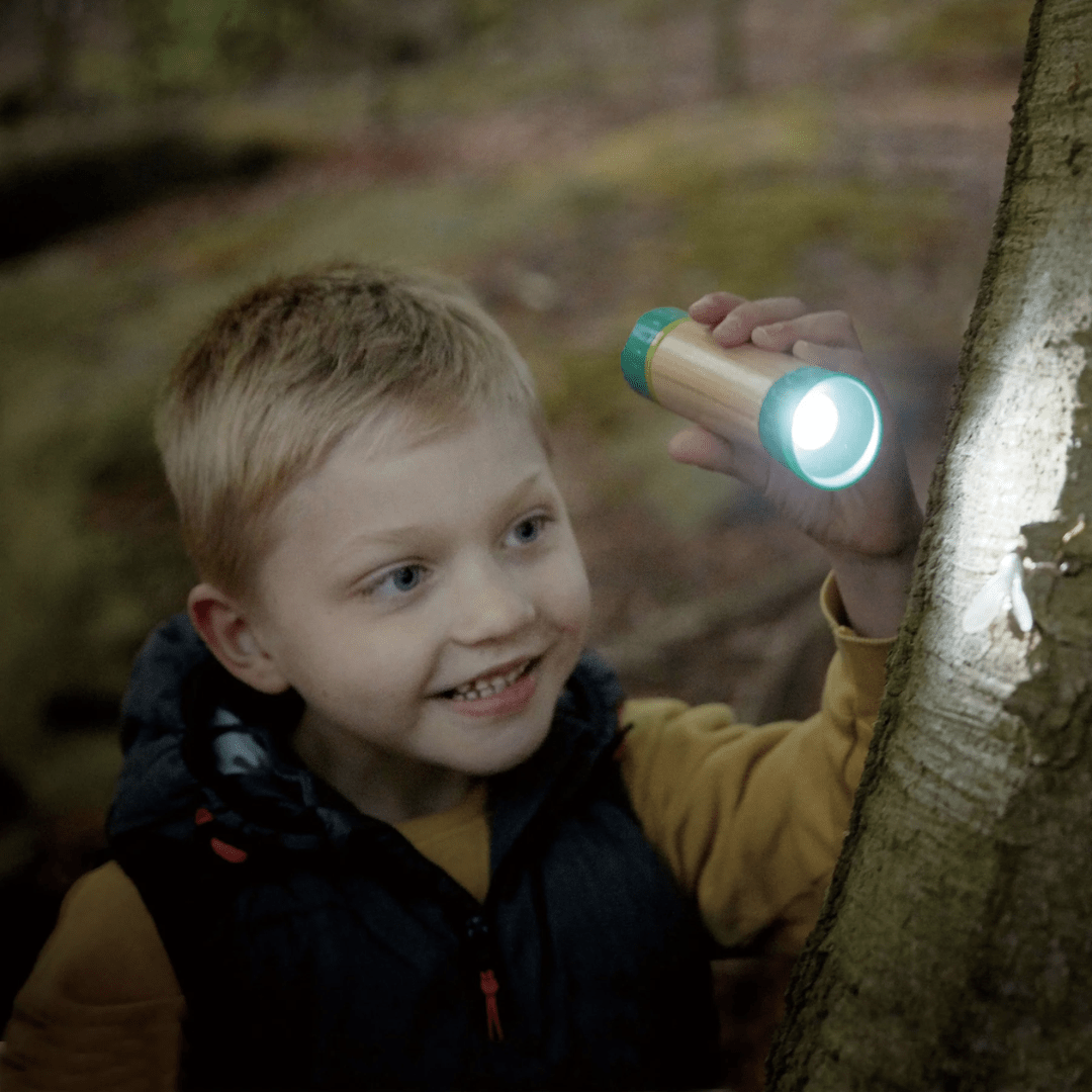 Little-Boy-In-The-Dark-Using-Hape-Hand-Powered-Flashlight-Naked-Baby-Eco-Boutique