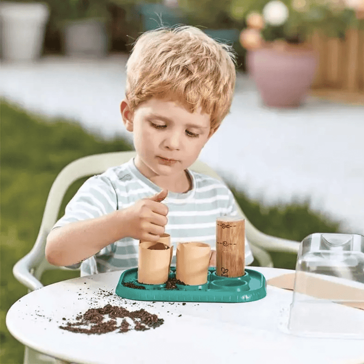 Little-Boy-Outside-With-Hape-Growing-Gardeners-Greenhouse-Naked-Baby-Eco-Boutique