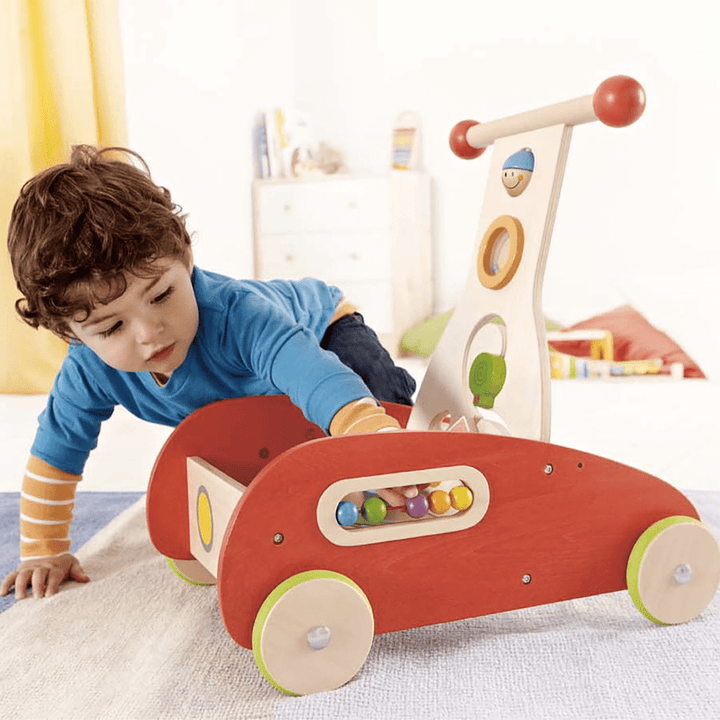 Little-Boy-Playing-In-Cart-On-Hape-Wonder-Walker-Naked-Baby-Eco-Boutique