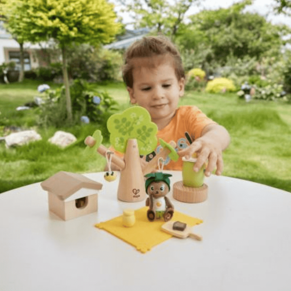 Little-Boy-Playing-With-Hape-Green-Planet-Bee-And-Honey-Set-Naked-Baby-Eco-Boutique