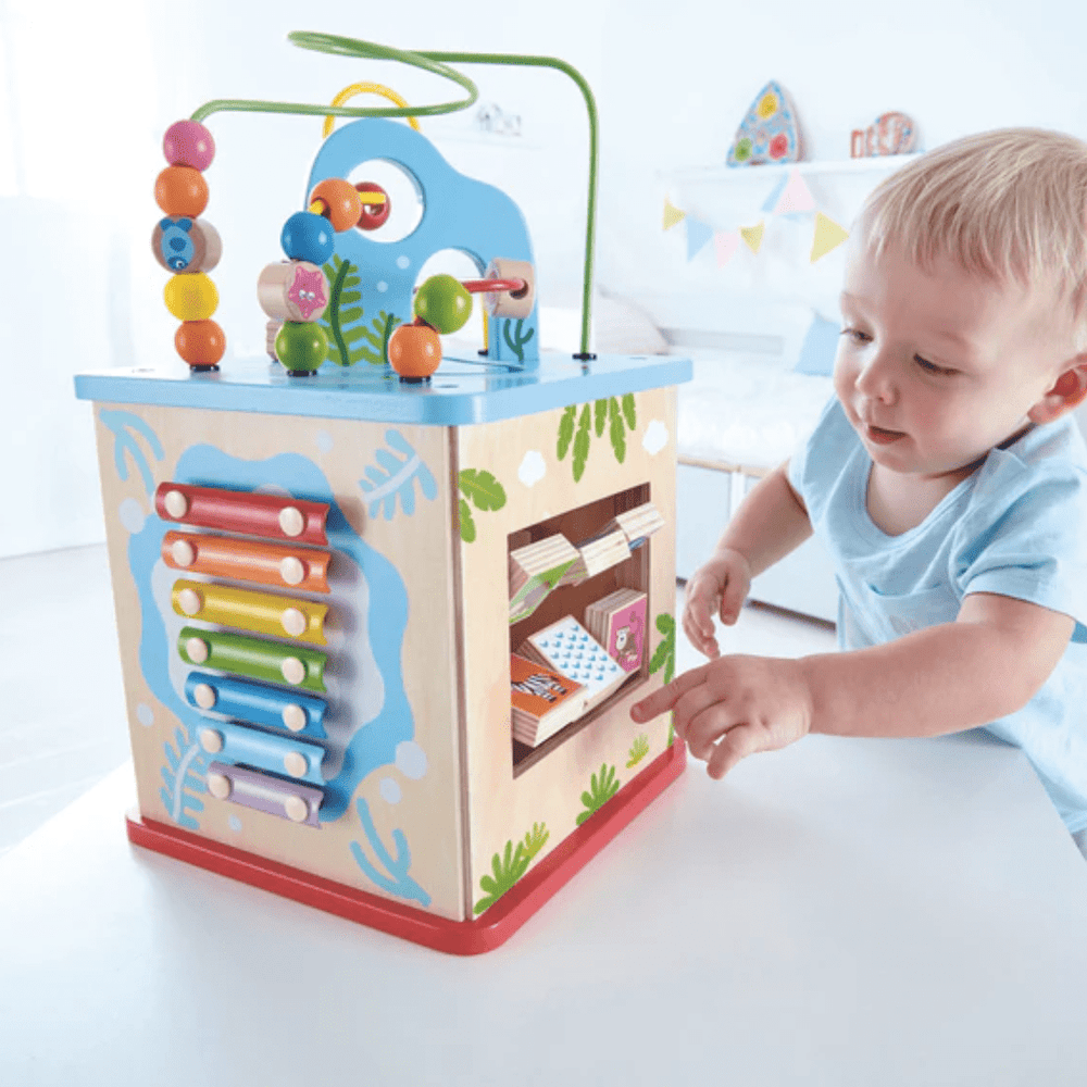 Little-Boy-Playing-With-Hape-Multi-Functional-Play-Cube-Naked-Baby-Eco-Boutique