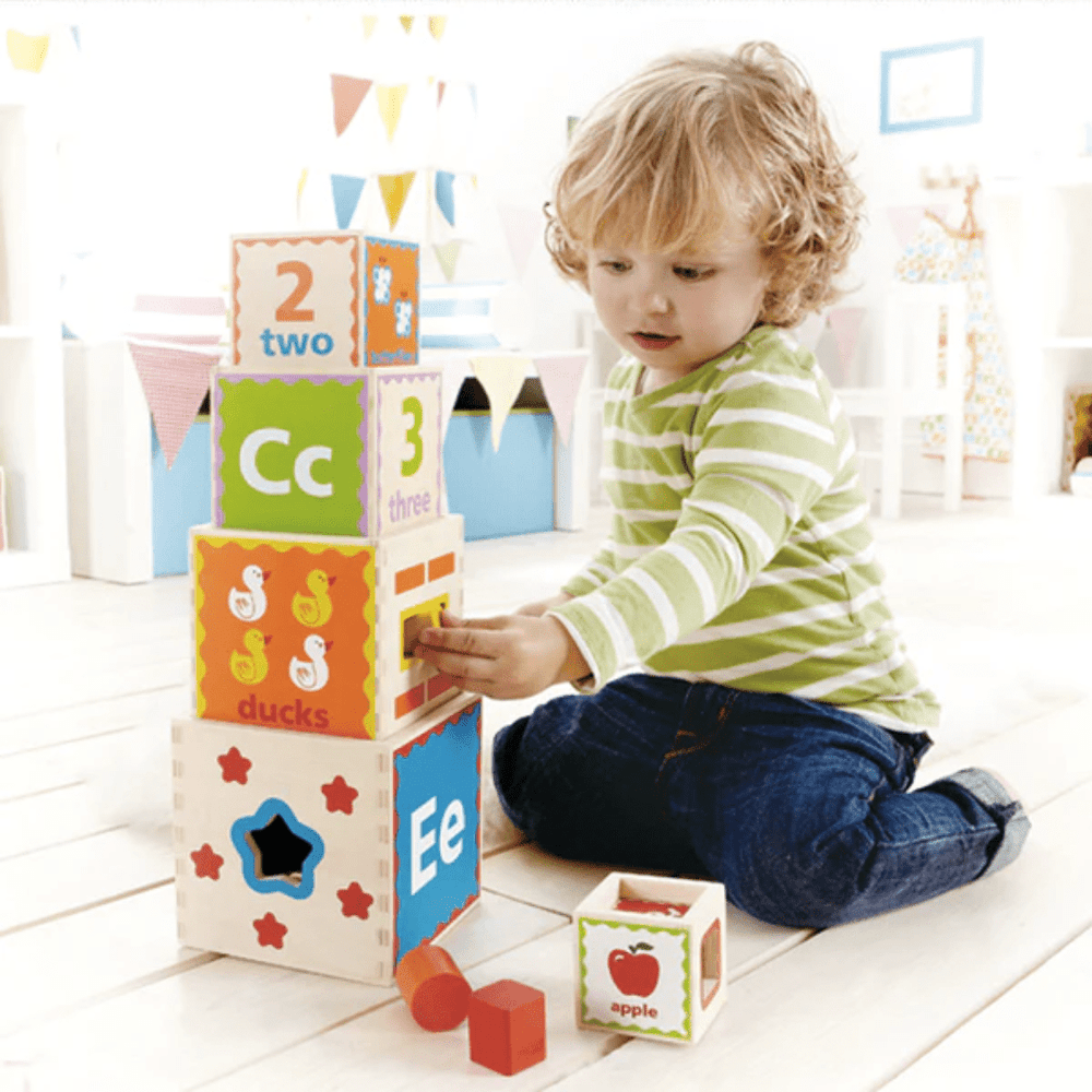 Little-Boy-Playing-With-Hape-Pryamid-Of-Play-Naked-Baby-Eco-Boutique