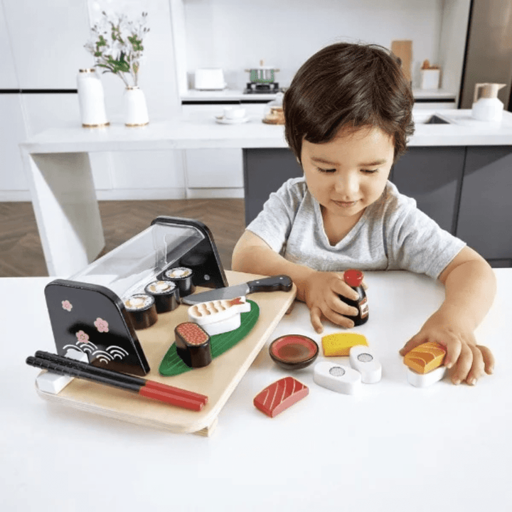 Little-Boy-Playing-With-Hape-Sushi-Time-Naked-Baby-Eco-Boutique
