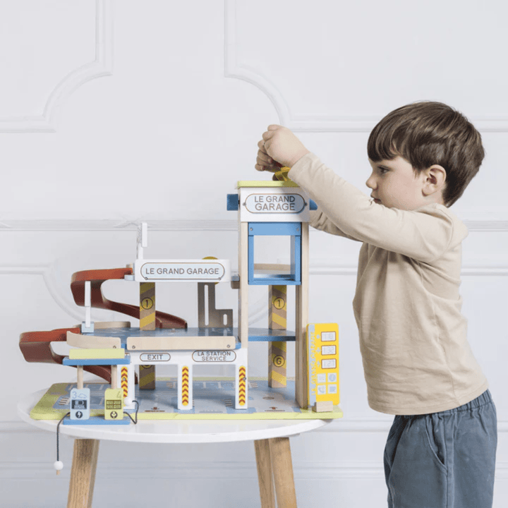 Little-Boy-Playing-With-Le-Toy-Van-Grand-Garage-Naked-Baby-Eco-Boutique