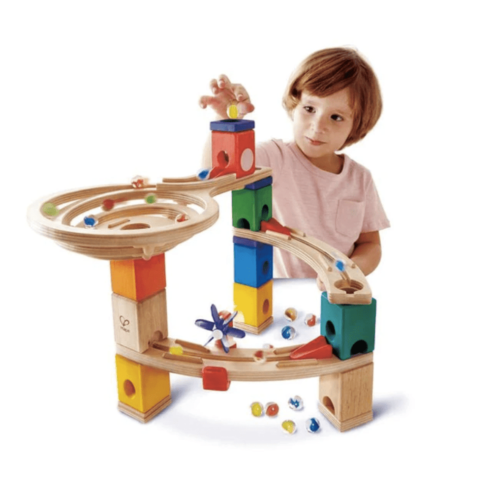 Little-Boy-Putting-Marble-Into-Hape-Quadrilla-Marble-Run-Race-To-The-Finish-Naked-Baby-Eco-Boutique