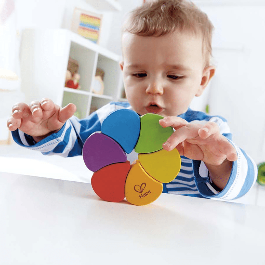 Little-Boy-Rolling-The-Hape-Rainbow-Rattle-Naked-Baby-Eco-Boutique