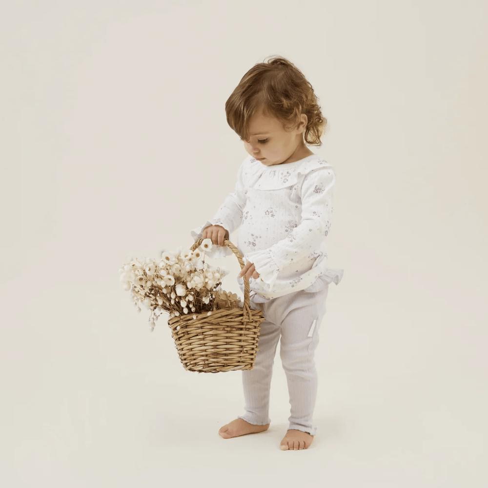 Little-Girl-Carrying-Basket-Of-Flowers-Wearing-Aster-And-Oak-Organic-Grace-Floral-Long-Sleeve-Top-Naked-Baby-Eco-Boutique