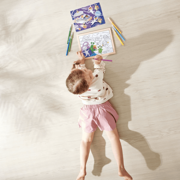 Little-Girl-Colouring-In-On-Hape-48-Piece-Double-Sided-Colour-Puzzle-Space-Friends-Naked-Baby-Eco-Boutique