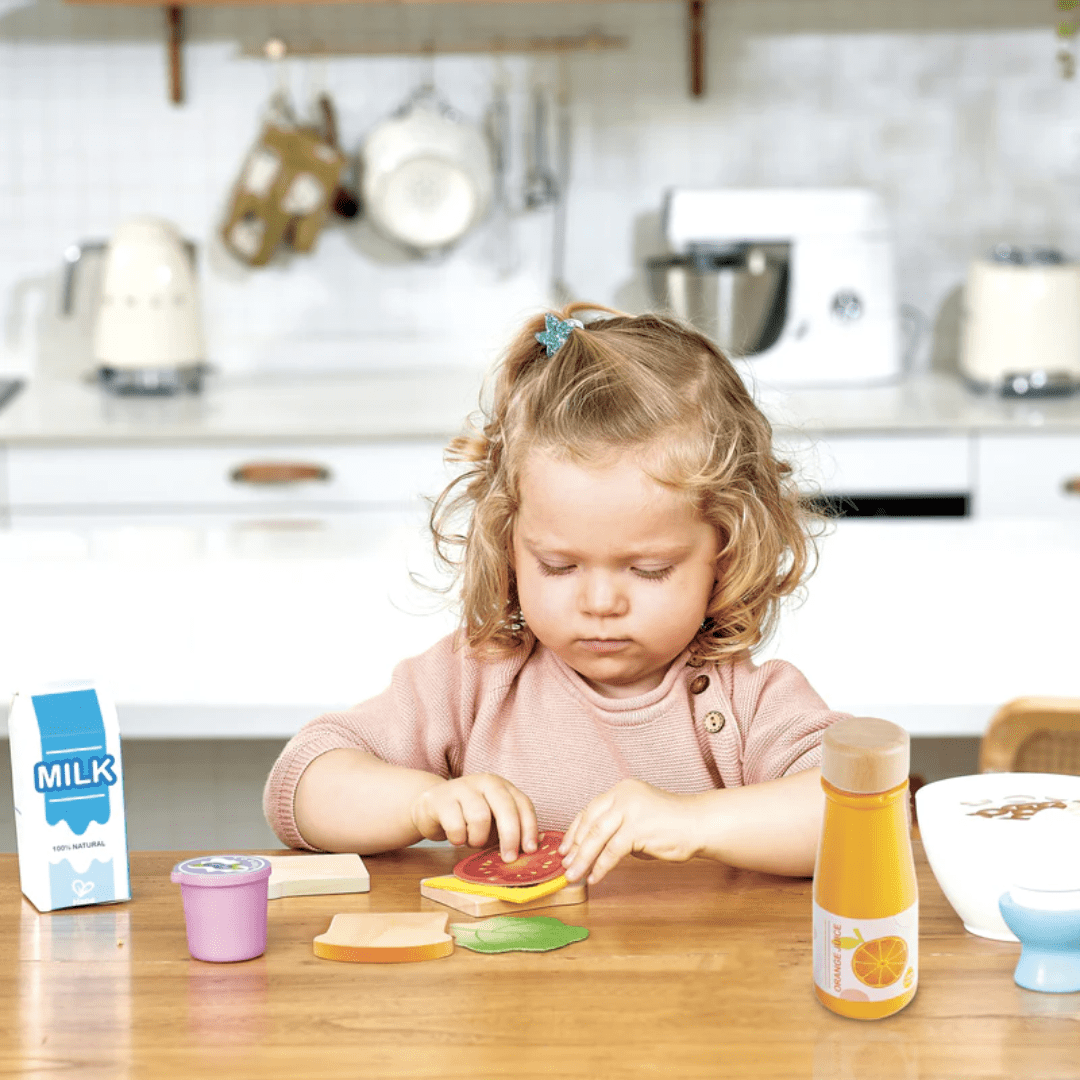 Little-Girl-Making-Sandwhich-With-Hape-Delicious-Breakfast-Playtime-Set-Naked-Baby-Eco-Boutique