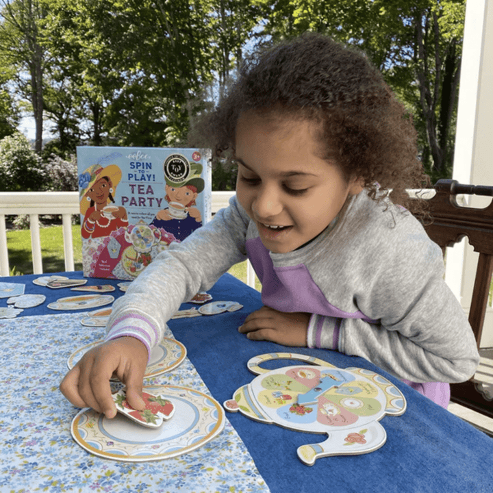 Little-Girl-Playing-Eeboo-Spin-To-Play-Game-Tea-Party-Naked-Baby-Eco-Boutique