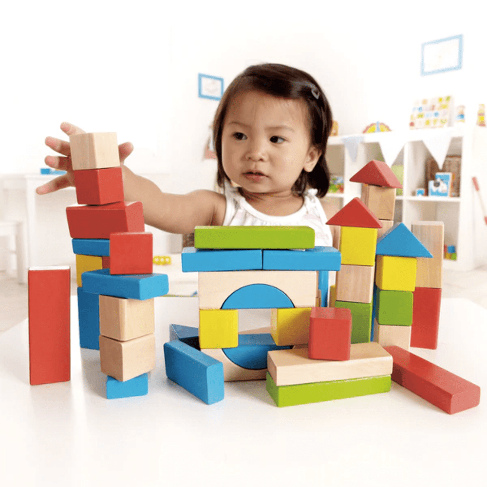 Little-Girl-Playing-With-Hape-50-Piece-Maple-Building-Blocks-Naked-Baby-Eco-Boutique
