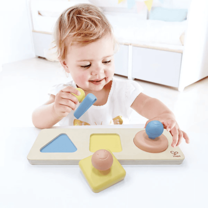 Little-Girl-Playing-With-Hape-Montessori-Mirror-Shape-Puzzle-Naked-Baby-Eco-Boutique