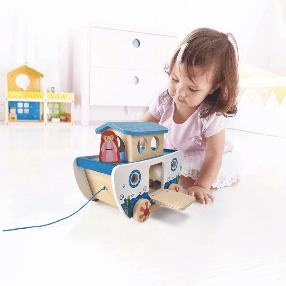 Little-Girl-Playing-With-Hape-Pull-Along-Noahs-Ark-Naked-Baby-Eco-Boutique